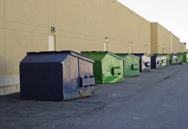 a row of construction dumpsters parked on a jobsite in Cadwell, GA